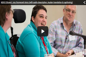 An image of Simone Stephens giving evidence to the NDIS Jury. Simone is an NDIS participant and was a focus group representative. There is a triangular shaped play button over the top of Simone's image, in the centre of the image. The button indicates if you click the link it will play a video of the short documentary about the Citizens' Jury Scorecard.