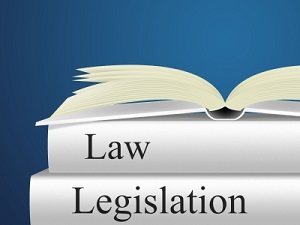 IMAGE: An open book sits on top of two other books titled Law and Legislation. Image courtesy of Stuart Miles at FreeDigitalPhotos.net